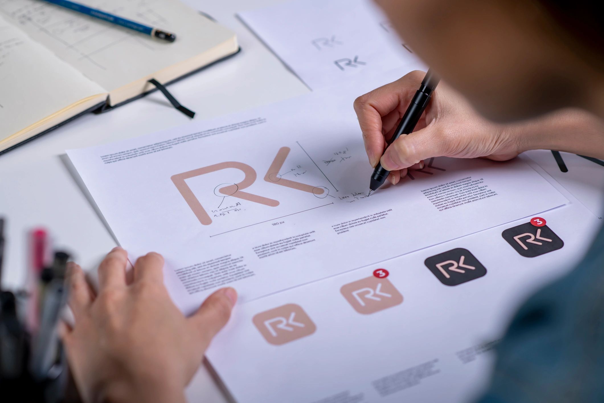 Close-up of logo sketches and branding concepts